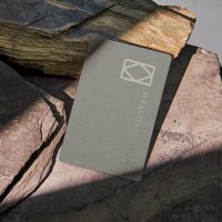 Mockup Business card with sunlight shadow on stone background. for mock-up design information company name.